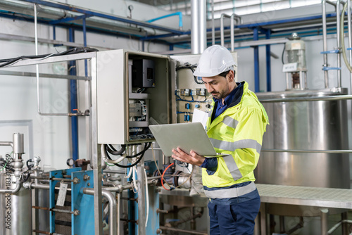 Mechanic or maintenance or electrical engineer checking main electrical control systems industrial plant. Utility fore man daily check power systems in process. Main Distribution Board, Switchboards