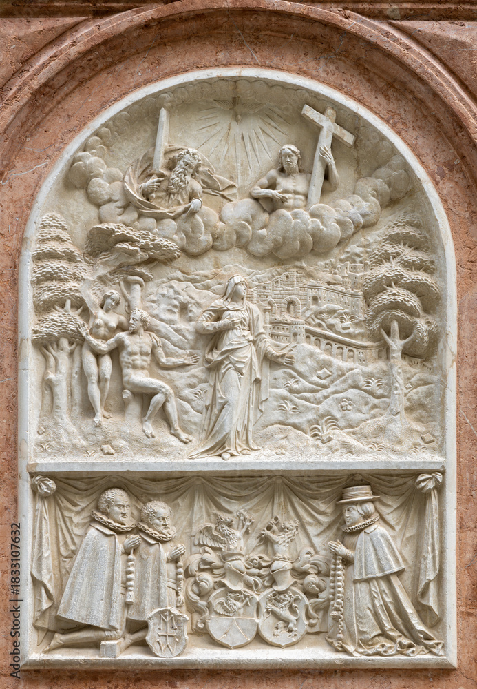 Obraz premium SALZBURG, AUSTIRA - SEPTEMBER 8 2025: The stone relief of Virgin Mary with the Adam and Eva on exterior wall of the chapel Margarethenkapelle in the St. Peter Abtei cemetery by unknown artist.