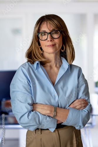 Wallpaper Mural Confident businesswoman standing with arms crossed at the office Torontodigital.ca