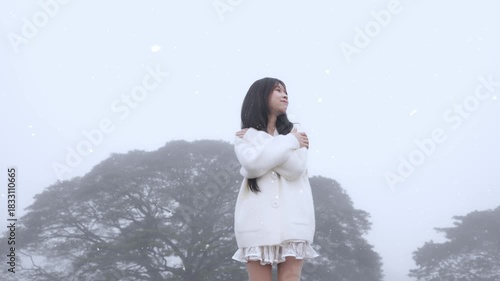  Beautiful young woman spinning in the winter snow in slow motion