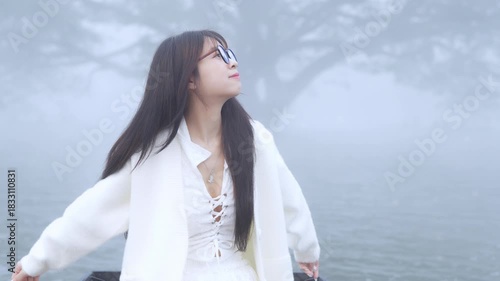  Beautiful young woman spinning in the winter snow in slow motion