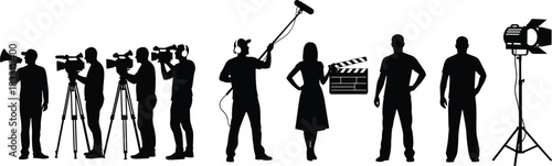 Silhouettes of film crew members with camera equipment and lighting filmmaking video camera