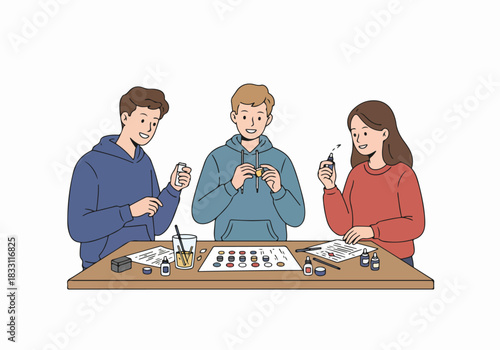 Young friends enjoying miniature painting and tabletop hobby crafting together, a creative leisure activity.