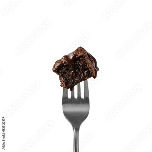 Decadent dark chocolate brownie square impaled on a silver fork against black backdrop