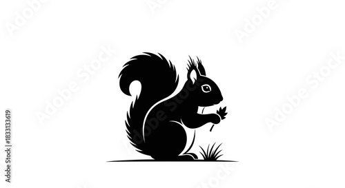 Silhouette of a Squirrel Holding a Nut in Black and White.