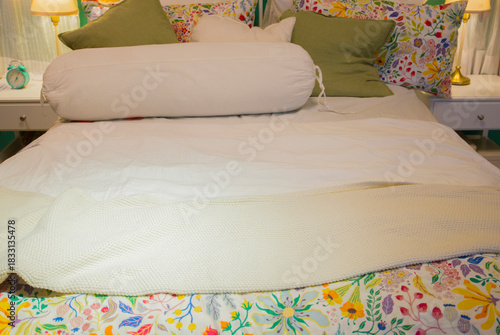 bed with pillows and bedclothes in hotel bedroom, interior design