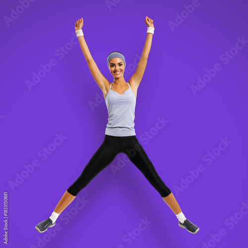 Full body of happy joyful woman jumping or doing fitness exercise, isolated violet purple color background. Fit girl with raise up hands, in sportswear, at studio. Square