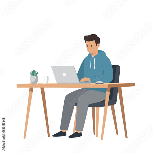 Focused Young Man Wearing Blue Hoodie Working Typing on Laptop Computer at Modern Desk Setup with Potted Plant and Coffee Cup in Brightly Lit Room Creating Content
