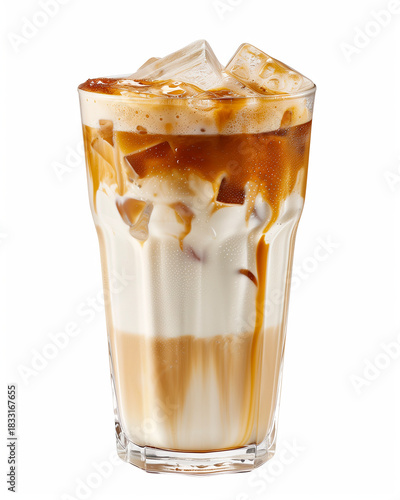 Tall glass of iced caramel latte with layers of milk, espresso and melting ice cubes. Refreshing and sweet beverage concept.