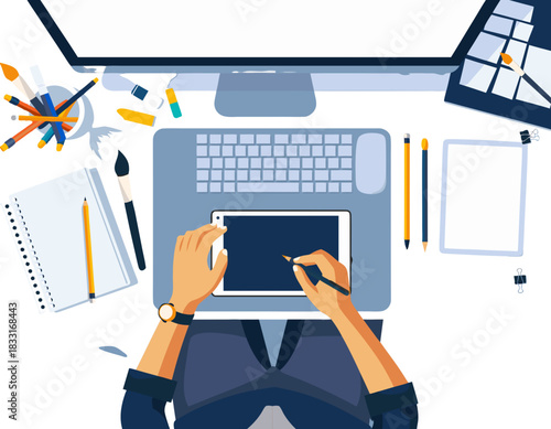 Overhead view of a person using a digital drawing tablet and stylus at a desk with a computer and art supplies, focused on creative work and digital art