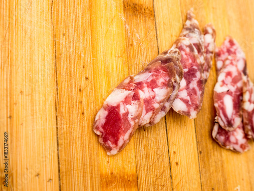 Sliced ​​sausage on a wooden board.