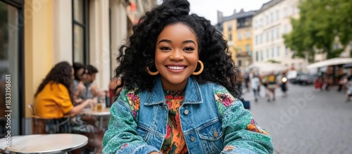Stylish Black Woman's Radiant Smile in a Floral Denim Jacket on a City Street