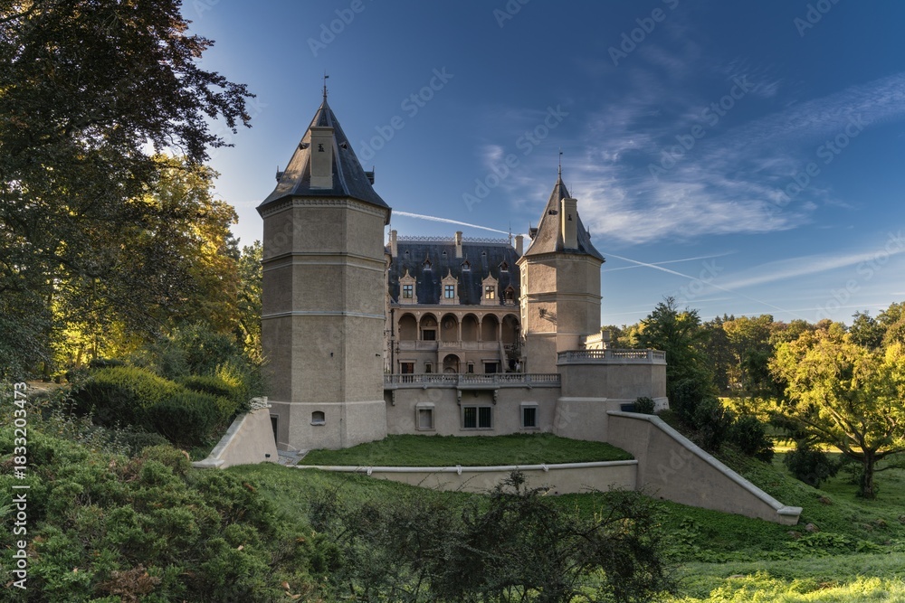 Fototapeta premium view of the historic magnate Renaissance Goluchow Castle surrounded by forest under a blue sky