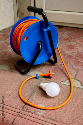 an extension cord and an energy-saving light bulb
