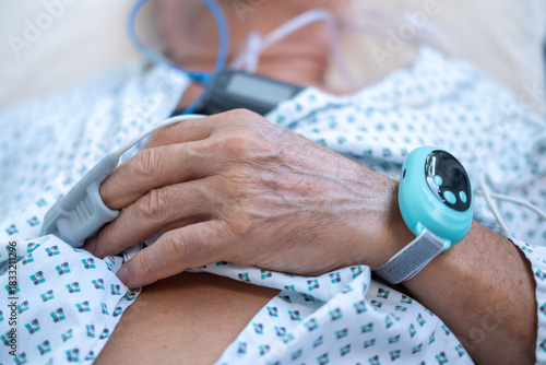 elderly man with sleep apnea monitoring device and fingertip pulse oximeter, senior male patient health tracker, adolescent sleep study equipment, breathing disorder research concept