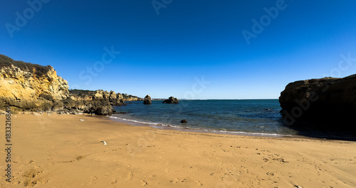 Amazing rocky scenic becahes of Algarve coast, Portugal. Breathtaking famous beach Praia da Marinha with yellow rocks with arc . 
