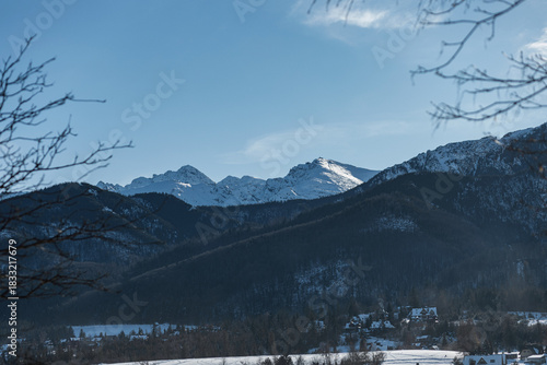 Fototapeta Naklejka Na Ścianę i Meble -  Majestic view of the snow-covered Tatra Mountains near Zakopane, Poland. Jagged peaks and dark evergreen slopes. High contrast winter landscape