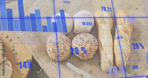 Fototapeta samoprzylepna Displaying seeded rolls and baguettes grouped on wood table with garlic and blue chart overlay