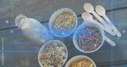 Displaying five white bowls holding cereals on gray woodgrain table, with milk bottle and spoons