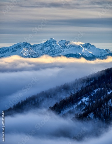 Majestic Snow-Capped Mountains Above Shrouded Fog and Clouds