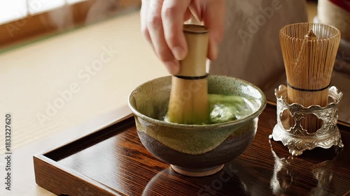 Preparing matcha green tea with traditional bamboo whisk for serene wellness ritual