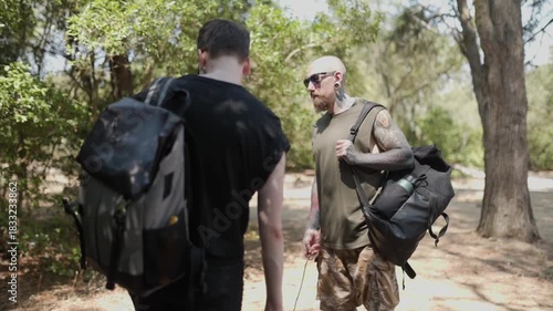 Wallpaper Mural Tattooed male couple hiking together in a sunny forest Torontodigital.ca