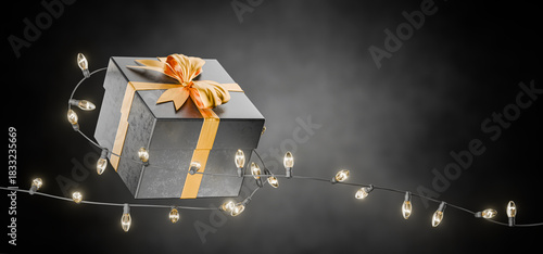 Dark gift box with gold ribbons. New Year's gift. Black gift box with Christmas garland. Christmas gift. Sale. Gift certificate. 3D rendering.