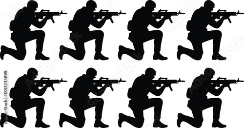 Silhouette of soldiers kneeling with rifles