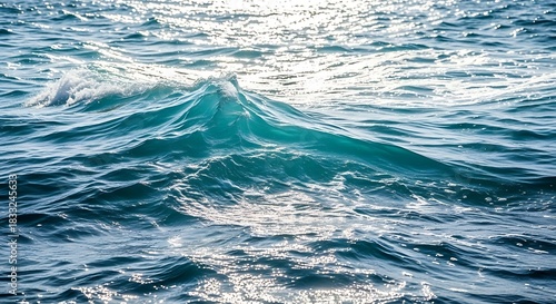 Fototapeta Naklejka Na Ścianę i Meble -  Turquoise ocean wave cresting with sunlight sparkling on the water surface blue