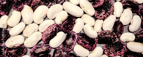 Red and white runner beans spread on a tray in closeup