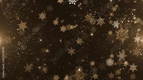 Luxury golden Christmas background with glittering gold particles, shimmering bokeh light, shiny stars and festive snowflakes gently falling.