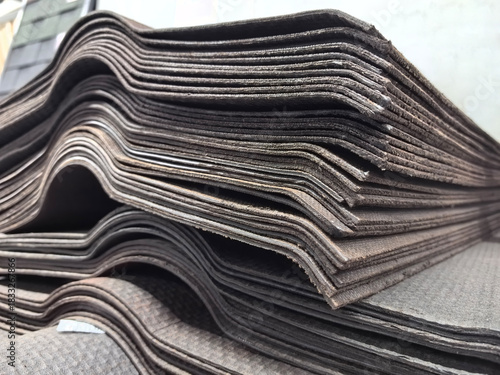 Stacked slate roofing materials ready for installation at a construction site