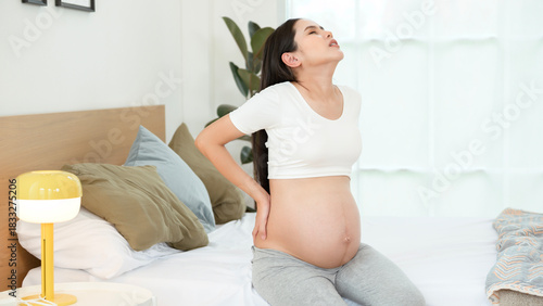 Pregnant Woman Experiencing Discomfort While Resting in a Cozy Bedroom Free Download Pregnant Woman Experiencing Discomfort While Resting in a Cozy Bedroom - GFXLoad