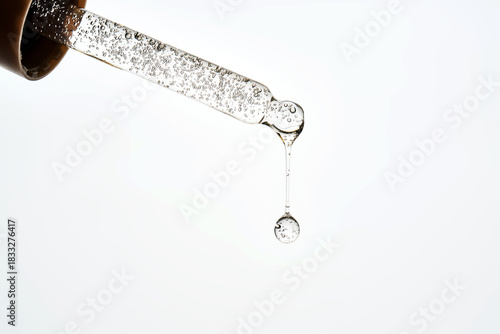 Cosmetic pipette dropping liquid serum with bubbles