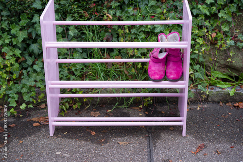 High angle view of pink children shoe rack give away standing outdoors at sidewalk at Swiss city of Zürich on an autumn day. Photo taken November 30th, 2025, Zurich, Switzerland.