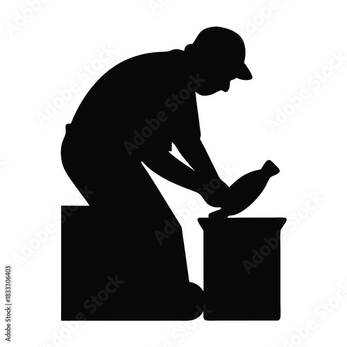 Silhouette of a man making pottery, focused and precise craftmanship displayed