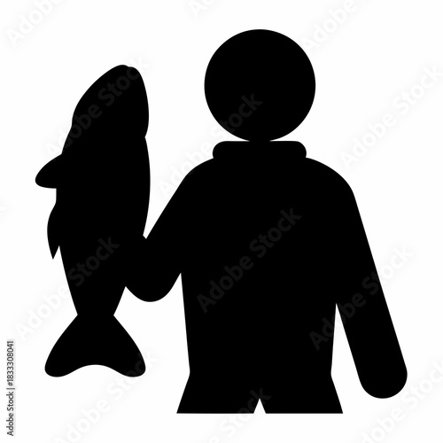 Silhouette of a fisherman holding a large fish he has just caught