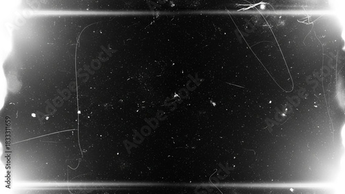 Abstract black and white film grain texture overlay with light leak effect, dust, scratches, and vintage grunge border for cinematic overlay or background design element