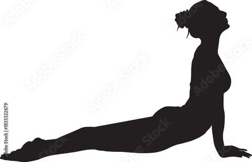 Silhouette of woman practicing yoga in cobra pose