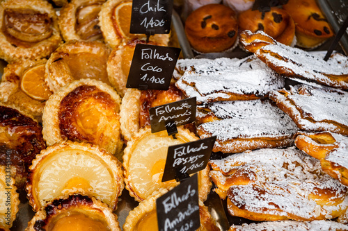 Portuguese pastries on a bakery market stall in Porto, Portugal