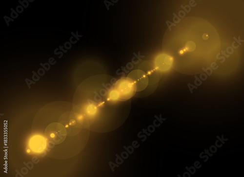 Golden diagonal lens flare with warm glow and soft light particles