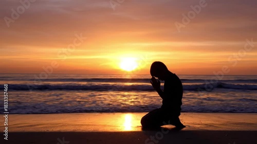 Wallpaper Mural Silhouette of person praying on beach at vibrant sunset, tranquil ocean waves Torontodigital.ca