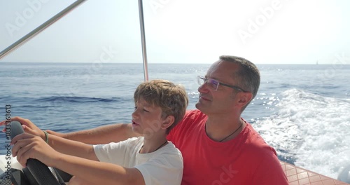 Father and son driving a speed motor boat