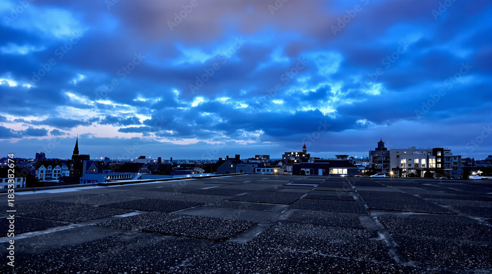 Obraz premium Cityscape Under Dramatic Blue Sky with Cloudy Evening View, Liminal