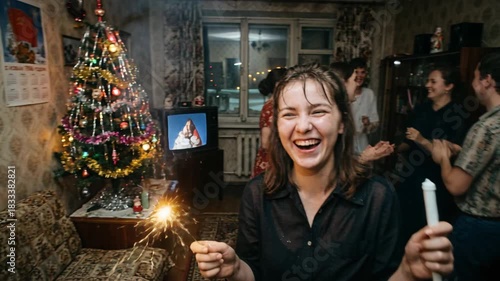 Laughing woman with sparkler at Soviet New Year party with dancing friends