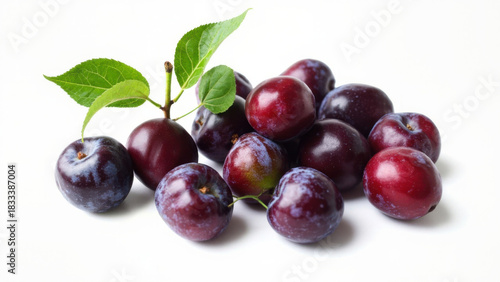 Wallpaper Mural Fresh plums with green leaves on a white background, studio shot Torontodigital.ca