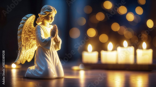 Angel figurine with golden wings kneeling in prayer beside glowing candles, creating a serene atmosphere, perfect for spiritual reflection and peaceful moments