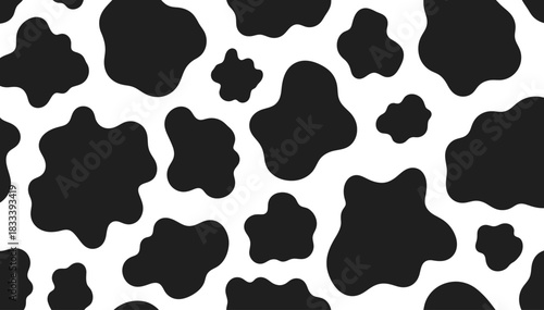 Seamless black and white cow pattern with irregular organic shapes for fabric and design