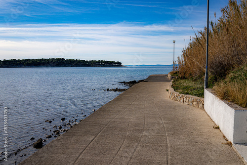 Fototapeta Naklejka Na Ścianę i Meble -  stone steps in a park by the sea, island of Rab, Croatia, Mediterranean, clear, blue sky