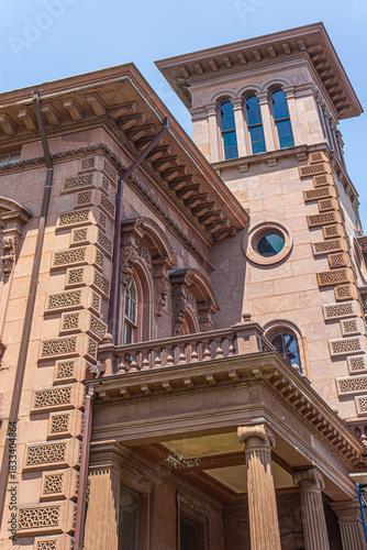 A historic building with intricate brickwork and various arched and circular windows, Portland, Maine